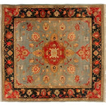 Artisan Floral Masterpiece rug front view; grey-blue field, red medallion with cream rosette, orange-red floral vine, thick black border, fringe edges