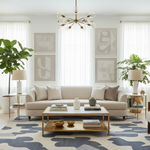 Modern living room with a beige sofa, coffee table, a contemporary wool rug, and decorative elements.