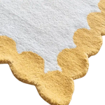 Close-up of an Asian Tigers and the Sun hand tufted area rug, showcasing its intricate wool design with warm gold and white tones. Perfect for adding a touch of elegance to your office or living room, this wool rug combines durability with style.