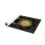 Astral Balance yoga mat partly rolled, gold sun face and crescent moon on swirling black design