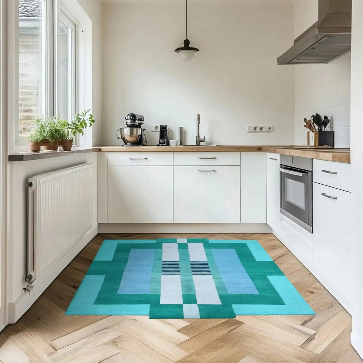 A stylish Aztec Blue hand-tufted wool area rug adds a splash of color to a modern kitchen setting. The geometric design complements the wooden floor, making it a perfect choice for dining rooms and bedrooms alike.