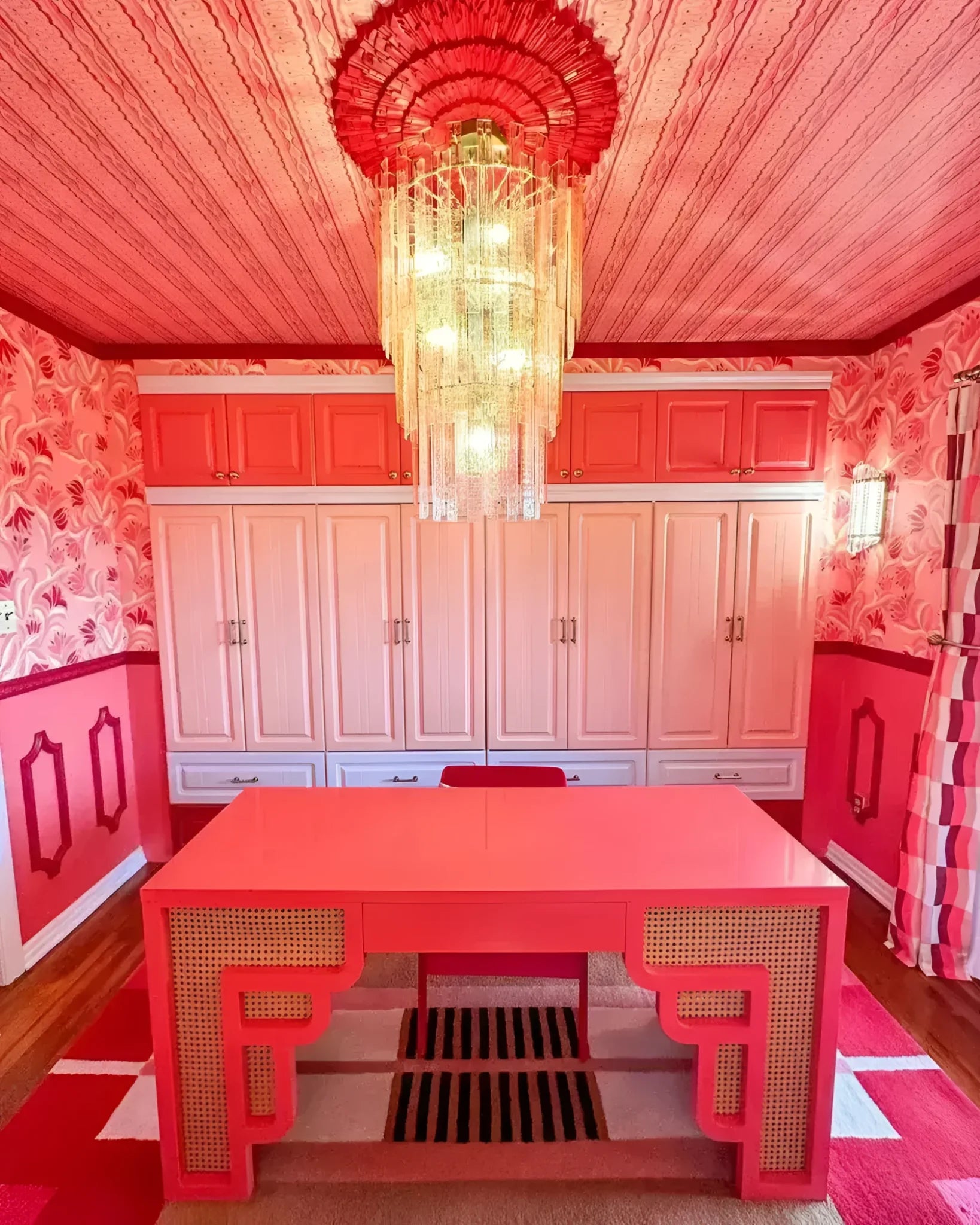 A vibrant contemporary rug in a striking Aztec Red design, perfect for adding a pop of color to any bedroom or living room. The hand-tufted wool area rug complements the bold pink decor and elegant chandelier in this stylish room, making it an ideal choice for those seeking large living room rugs with a modern flair.