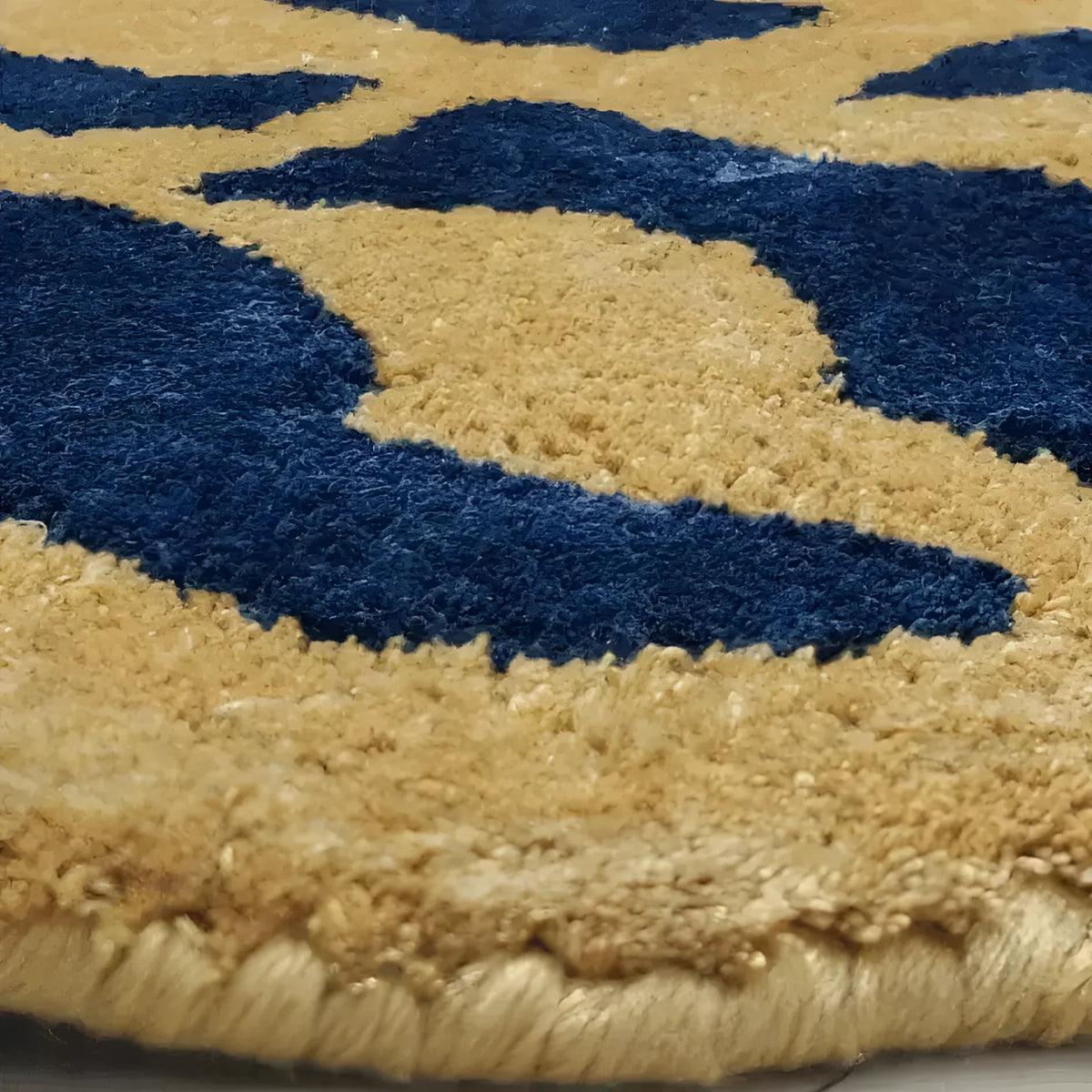 Close-up of an authentic Tibetan area rug, hand-tufted in wool, showcasing intricate tiger pattern in rich blue and golden hues. Perfect for adding an exotic touch to your living room or office space.