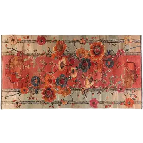 Top view of an area rug titled 'Autumn's Embrace Knotted Wool Rug' featuring a vibrant floral pattern with rich orange and red hues, accented by intricate botanical designs. This elegant wool rug adds a warm, artistic touch to any room decor.