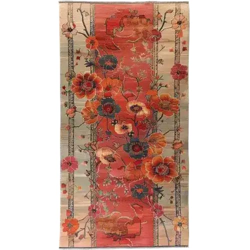 Top view of the Autumn's Embrace Knotted Wool Area Rug featuring vibrant floral patterns in warm autumn hues. The intricate design showcases large blossoms in shades of orange, red, and pink against a soft, neutral background, creating a cozy and inviting atmosphere.