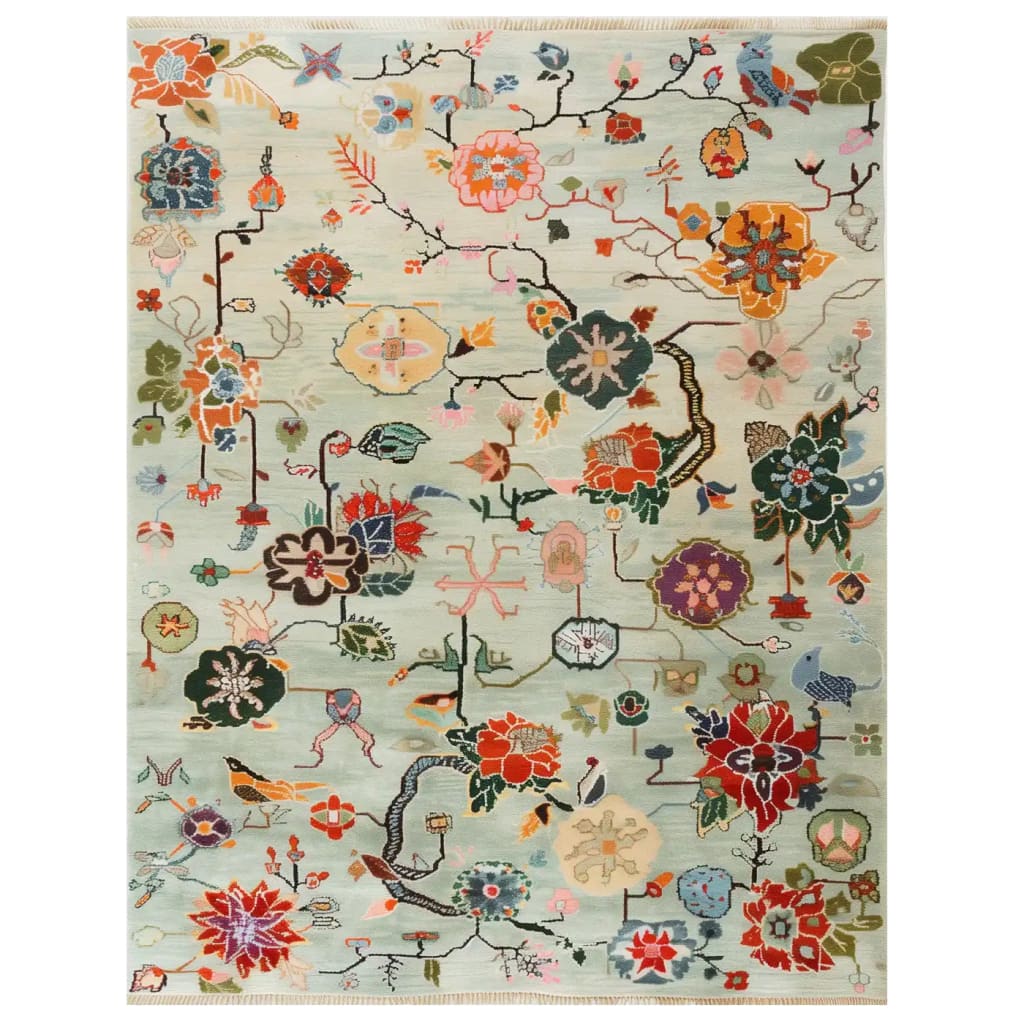 Top view of the Avant Bloom Knotted Wool Area Rug featuring a whimsical, colorful floral design on a light background, showcasing intricate patterns and vibrant hues.