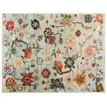 Top view of the Avant Bloom Knotted Wool Rug showcasing a vibrant array of abstract floral patterns. The area rug features a harmonious mix of colors, including reds, greens, blues, and oranges, set against a soft background, creating an inviting and artistic ambiance.