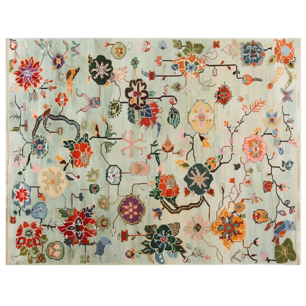 Top view of the Avant Bloom Knotted Wool Rug showcasing a vibrant array of abstract floral patterns. The area rug features a harmonious mix of colors, including reds, greens, blues, and oranges, set against a soft background, creating an inviting and artistic ambiance.