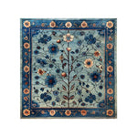 The Azure Eternal Knotted Wool Rug features an intricate floral design with vibrant blue and beige blossoms on a soft blue background, bordered by a detailed floral pattern. This exquisite area rug adds a touch of elegance and sophistication to any room.