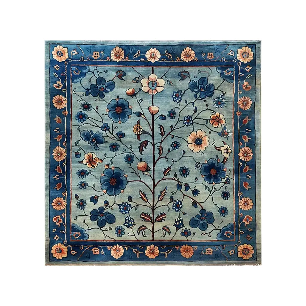 The Azure Eternal Knotted Wool Rug features an intricate floral design with vibrant blue and beige blossoms on a soft blue background, bordered by a detailed floral pattern. This exquisite area rug adds a touch of elegance and sophistication to any room.