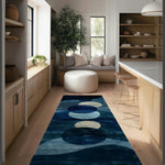 Deep blue wool runner with abstract circular orbs in cream and azure, in a light-wood kitchen with a window seat