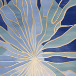 Top view of the Azure Stained Glass Hand Tufted Rug, showcasing an intricate abstract design in shades of blue and beige. This contemporary wool area rug is perfect for adding a touch of elegance to large living rooms.