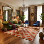 Luxurious living room with green sofa, a floral pattern rug, blue armchair, and decorative elements.