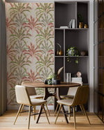 Banana grove leaf wallpaper in a dining nook with round wood table, chairs and grey shelving