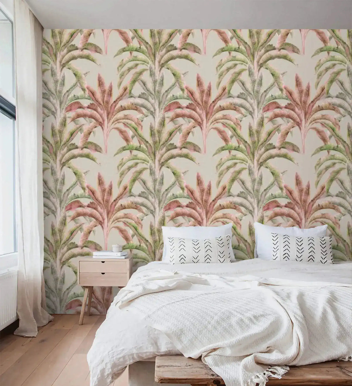 Banana grove wallpaper with pink and green palms behind a bed with white linens in a bright bedroom