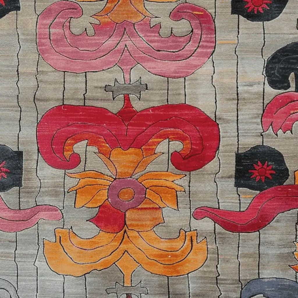 Close-up of the Baroque Fire Bloom Hand Tufted Area Rug showcasing intricate abstract floral patterns in vibrant reds, oranges, and pinks against a subtle gray background. The design highlights a luxurious and artistic touch suitable for elegant home decor.