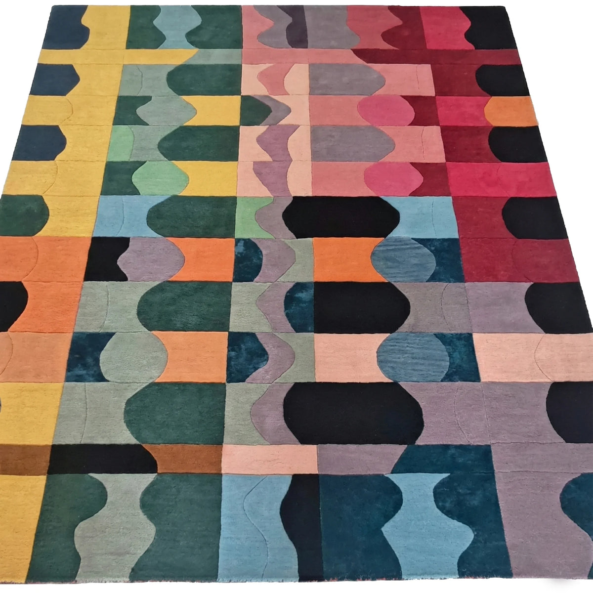 Multicolored geometric patterned rug on a white background