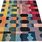 Multicolored geometric patterned rug on a white background