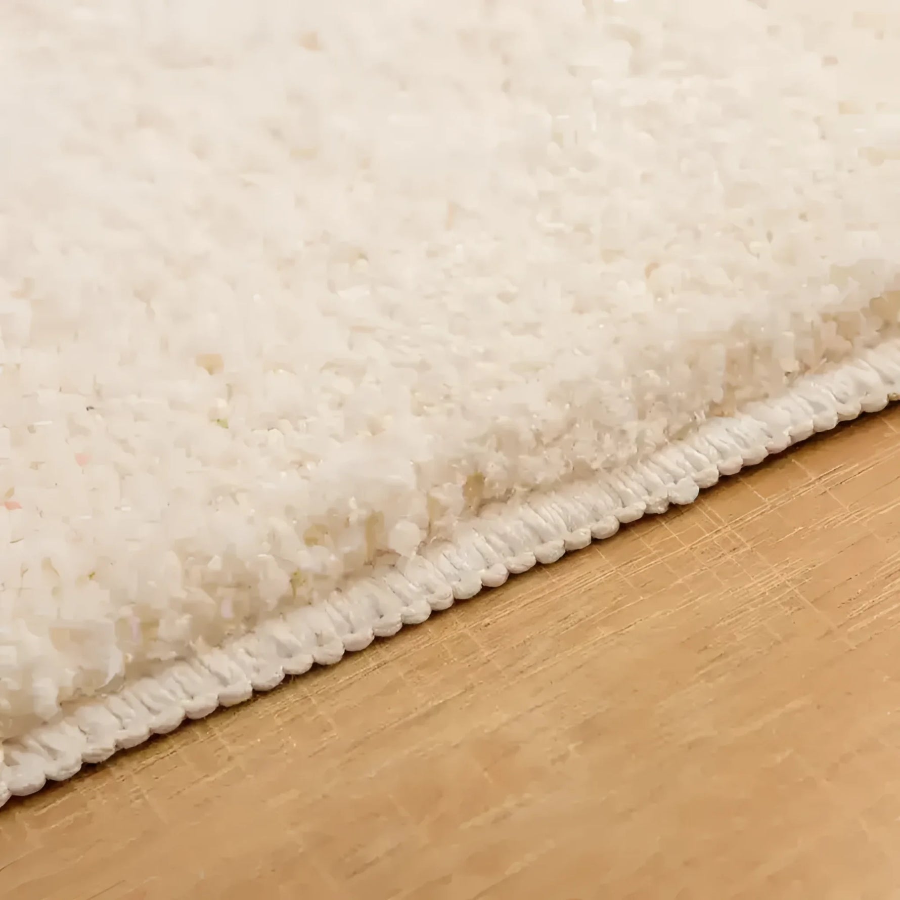 Close-up view of the Bebe Bathroom Mat showcasing its plush, textured surface and sturdy stitching, ideal as an area rug for enhancing bathroom decor.