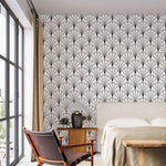 Bedroom with upholstered bed and leather chair against monochrome round line fan wallpaper