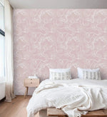 Bedroom with wood nightstand against pink floral sketch wallpaper, white outlined flowers