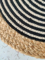 Close-up of a Beige and Black Oval Jute Rug, showcasing its intricate woven pattern. This stylish area rug is perfect for adding a natural touch to your living room, bedroom, or as a bathroom runner rug. The durable jute material makes it ideal for kitchen rugs and hallway runner rugs, offering both elegance and functionality.