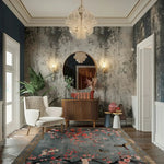 Bird and blossom rug in entryway with boucle chair, fluted console and textured wall