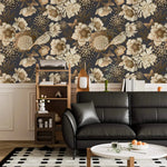 Bird garden wallpaper in living room, sepia peonies and songbirds on navy above black leather sofa
