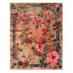Birdsong in Bloom Hand Knotted Rug showcases a vibrant floral design with birds perched among lush pink and blue blossoms. This wool area rug is perfect for adding a touch of elegance to any office space, combining beauty and functionality in large area rugs.