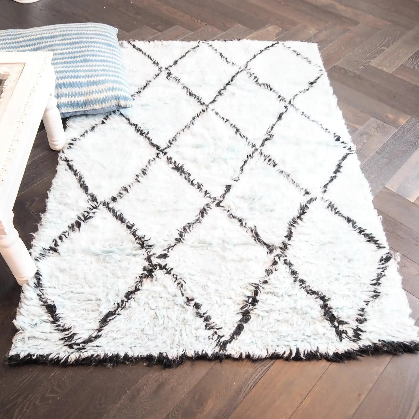 Top view of a Black and Blue Diamonds Shag Wool Rug, showcasing its plush texture and geometric pattern, perfect for enhancing the comfort and style of any living room area. Ideal as a wool rug or a centerpiece for living room area rugs.