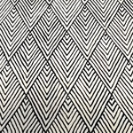 Top view of a Black and Cream Art Deco Geometric Hand Tufted Wool Area Rug, perfect for adding a stylish touch to bedrooms and living rooms. The rug features a striking geometric pattern, making it an ideal choice for those seeking elegant bedroom area rugs.