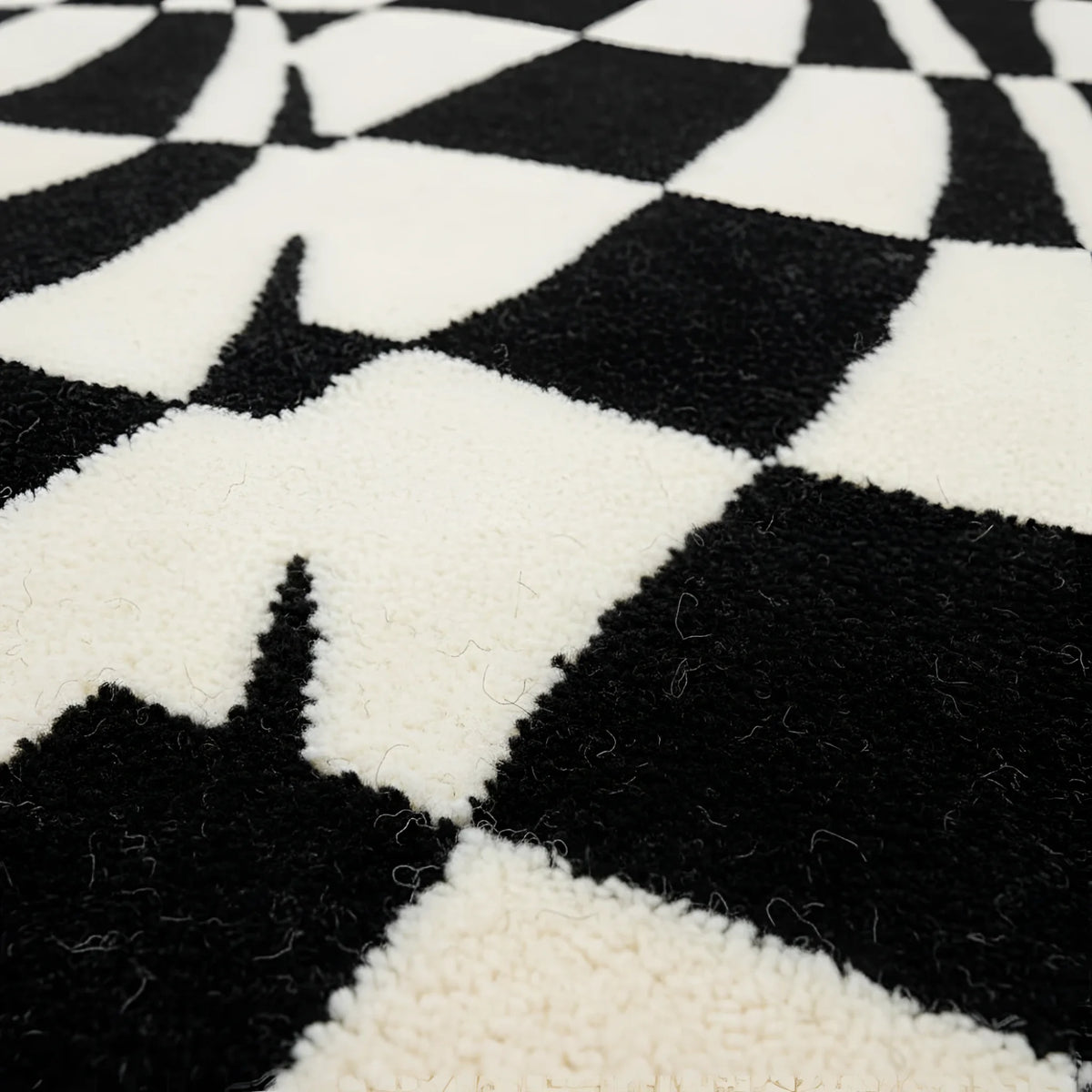 Close-up of a black and white checkered pattern rug.