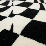 Close-up of a black and white checkered pattern rug.