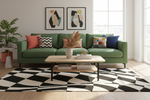 Green sofa with colorful pillows in a living room with abstract art and a checkered rug.