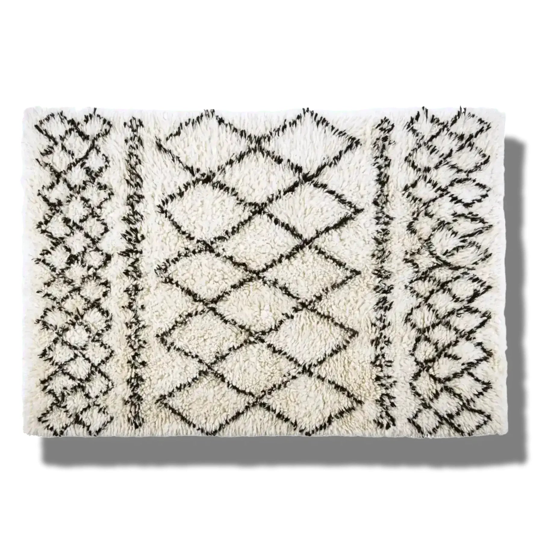 Top view of a Black and White Diamonds Shaggy Wool Area Rug, perfect as a runner rug for bathrooms, kitchens, or hallways. The rug features a striking black geometric diamond pattern on a white shaggy wool texture, adding a touch of elegance to any space.