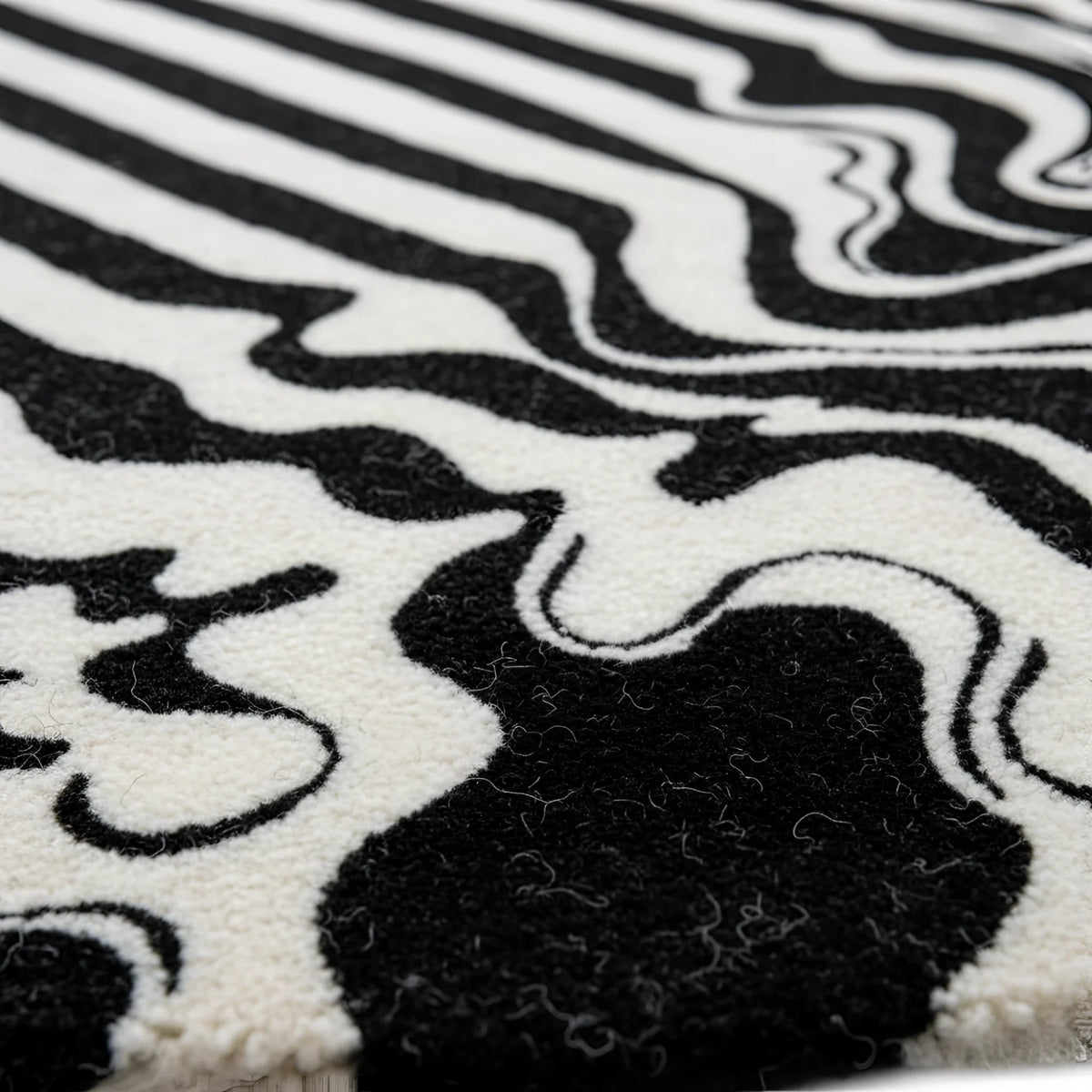 Close-up of a black and white patterned rug with abstract design