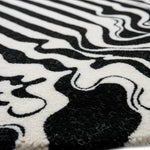 Close-up of a black and white patterned rug with abstract design