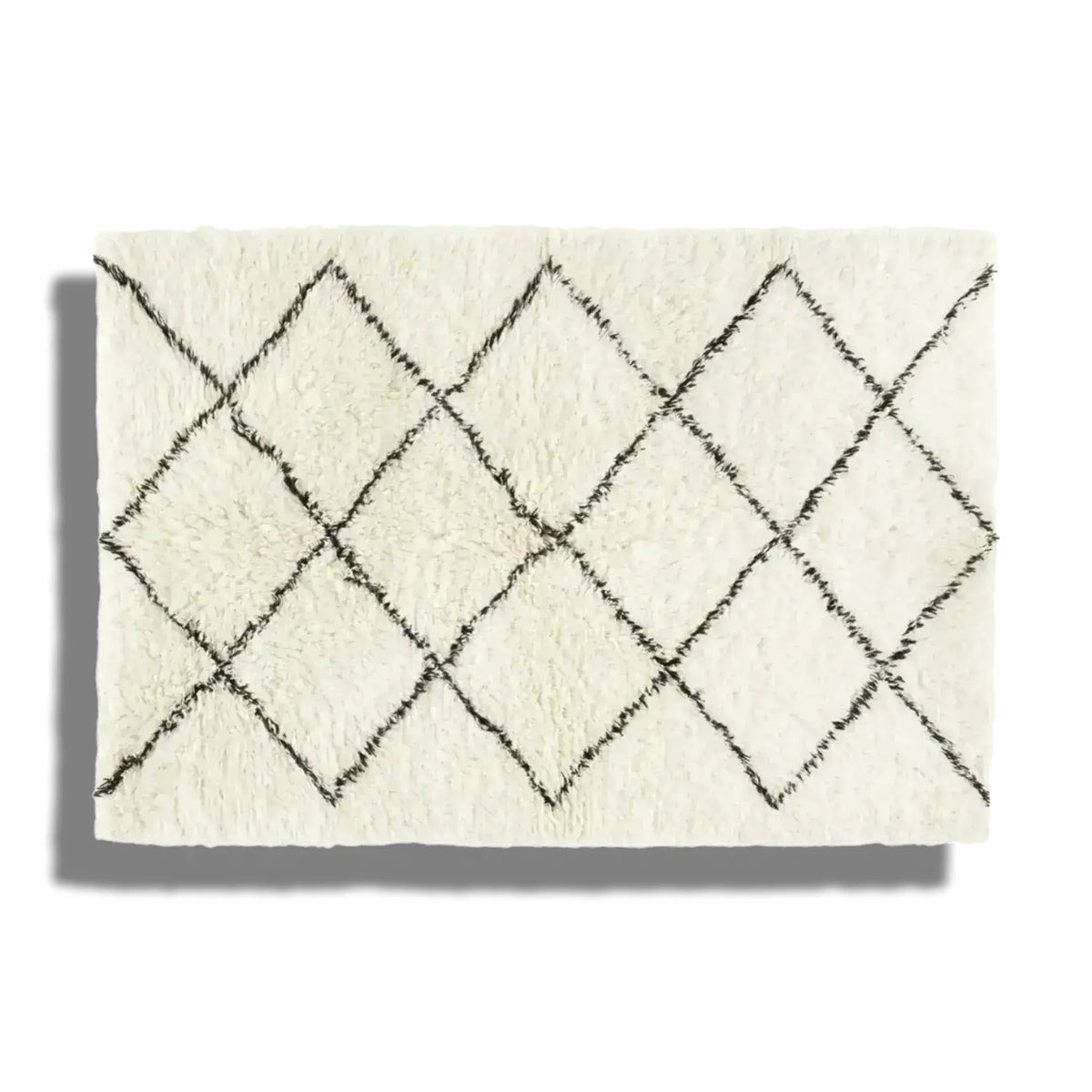 A stylish black and white minimalist shaggy hand-woven wool area rug featuring a diamond pattern, perfect for use as a bathroom runner rug, kitchen rug, or bedroom rug. This versatile piece can complement any bedroom, dining room, or hallway runner setup.