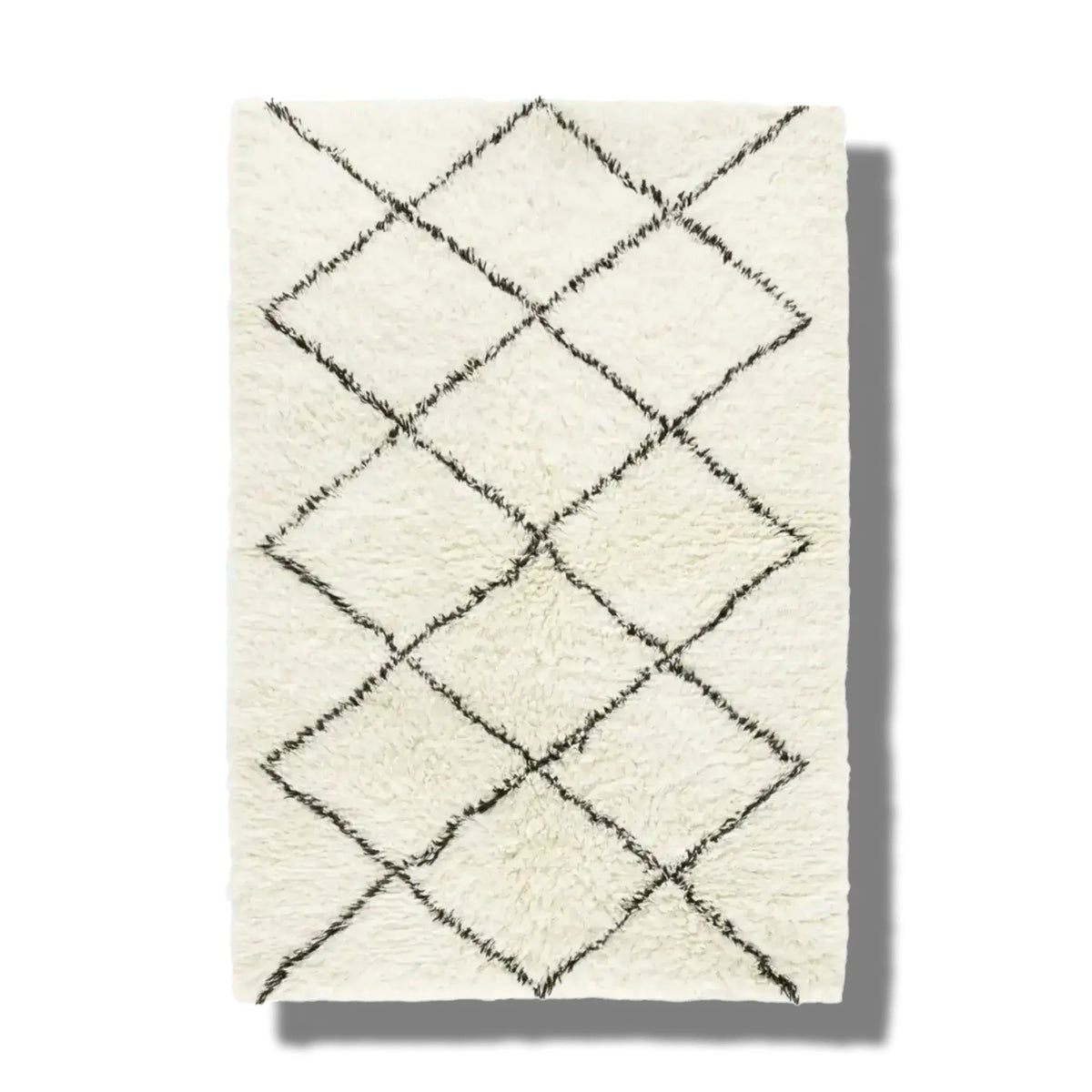 Top view of a black and white minimalist shaggy hand woven wool area rug featuring a geometric diamond pattern. Ideal for use as a bathroom runner rug, kitchen rug, bedroom rug, or hallway runner, adding a cozy touch to any space.