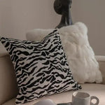 Black and white zebra print throw pillow cover with fringes, adding a stylish touch to any living space.