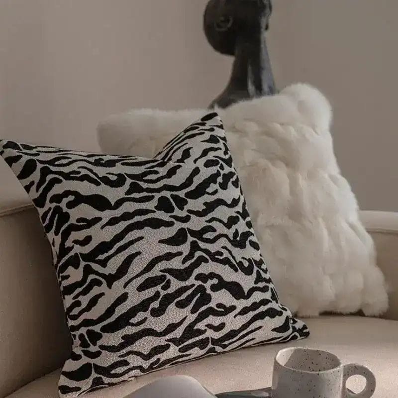 Black and white zebra print throw pillow cover with fringes, adding a stylish touch to any living space.