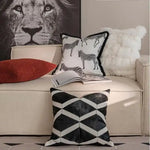 Black and white throw pillow cover featuring zebra patterns and fringes, perfect for home decor.