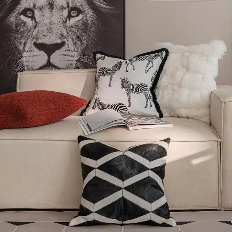 Black and white throw pillow cover featuring zebra patterns and fringes, perfect for home decor.
