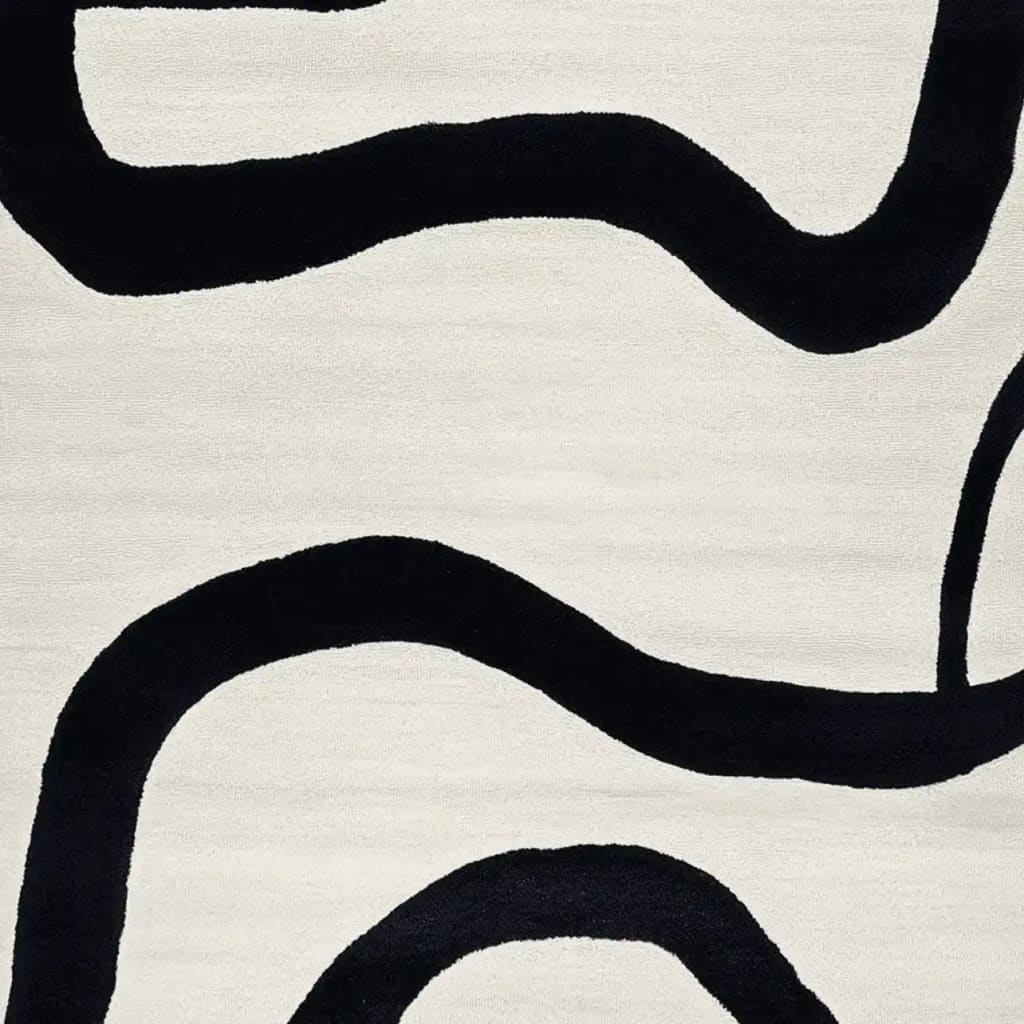 Close-up of the Black Current Flow Hand Tufted Area Rug, featuring a contemporary abstract design with bold black curves on a soft cream background. Perfect for adding a modern touch to large living room areas, this wool rug enhances both style and comfort.