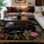 A beautifully decorated living room featuring a Black Floral Symphony Hand Tufted Area Rug, ideal for large living spaces. The 8x10 wool rug showcases vibrant floral patterns in rich colors, enhancing the cozy ambiance of the room. Positioned under a sleek coffee table, this large living room rug adds elegance and warmth to the space.