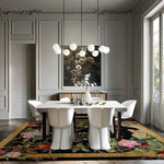 Black Floral Symphony hand-tufted rug in formal dining room — black field, bright pink tropical florals and foliage, gold border