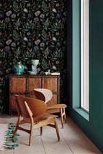 Black floral wallpaper with thistles and ferns by carved cabinet, teal vases and wood chair