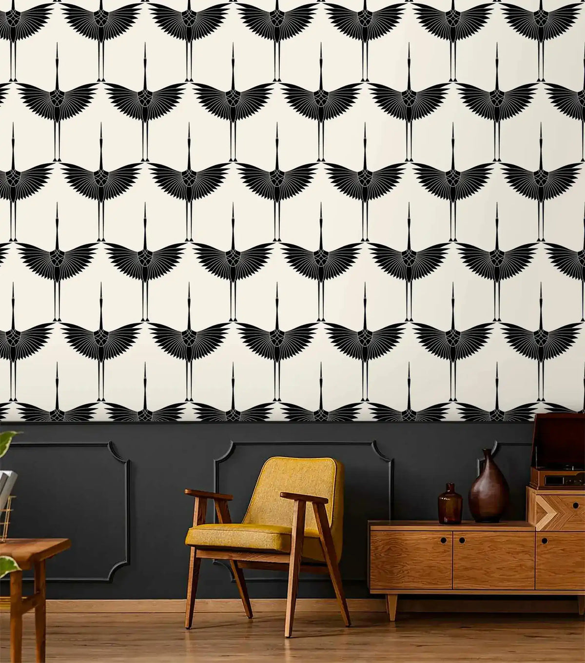 Black Heron crane wallpaper over charcoal wainscoting, mustard armchair and walnut credenza below