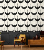 Black Heron crane wallpaper over charcoal wainscoting, mustard armchair and walnut credenza below