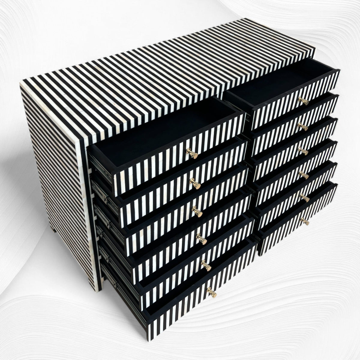 Black and white striped storage unit with multiple drawers on a white background